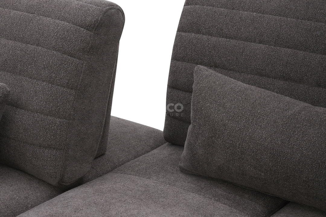 Gray upholstered chair with quilted design.