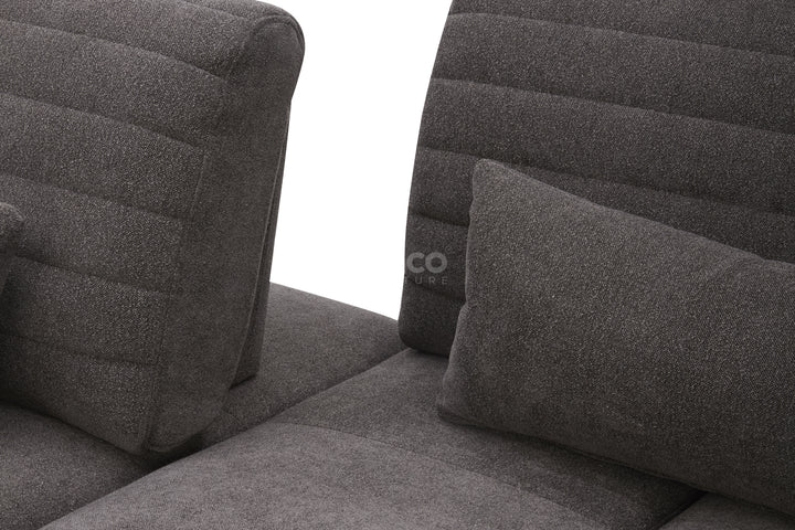 Gray upholstered chair with quilted design.