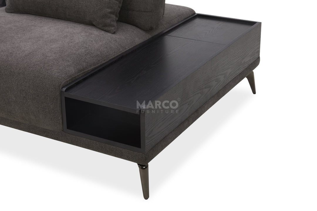 Gray sofa with a black storage compartment on a white background, featuring the brand 'Marco Furniture'.