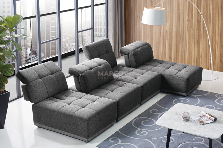 Gray sectional sofa in a modern living room with a coffee table and decorative items.