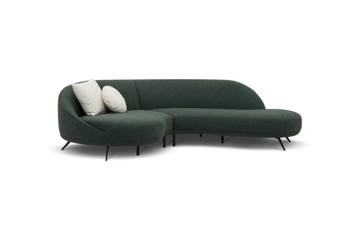 Green sectional sofa with white cushions on a white background