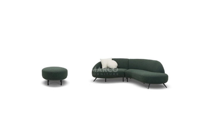 Green sectional sofa with a matching ottoman on a white background
