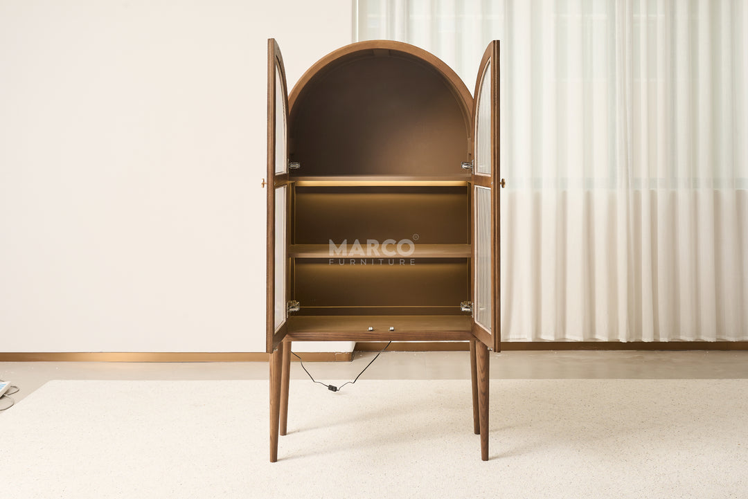 Wooden bar cabinet with open doors on a white floor and light-colored wall background