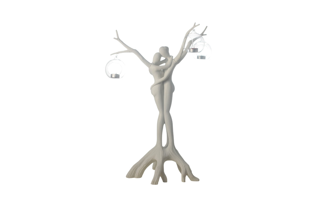 White decorative sculpture of a woman with branches for hair on a white background