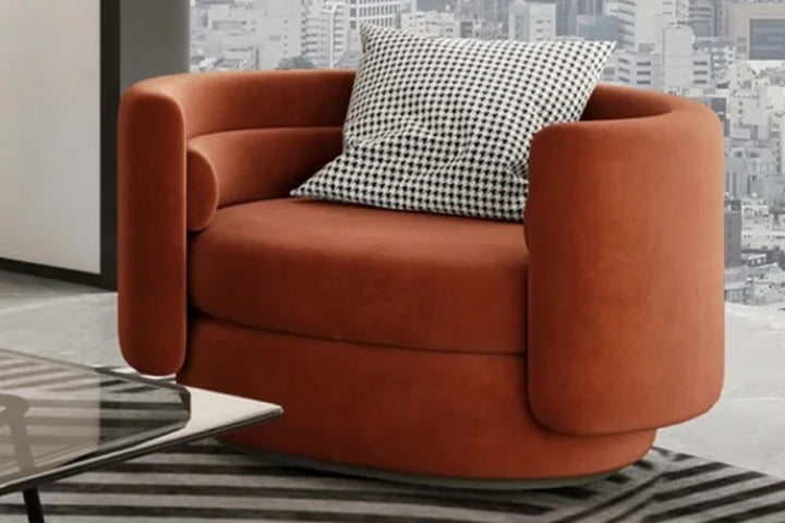 Orange armchair with a checkered pillow in a room with cityscape wallpaper.