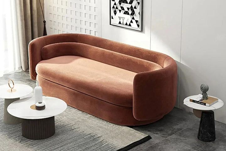 Brown sofa in a modern living room with side tables and decor.