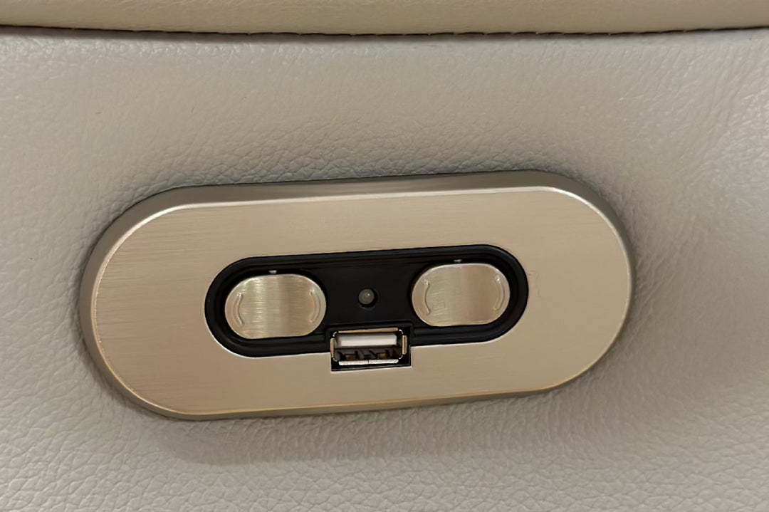 Car interior USB port and charging socket on beige leather