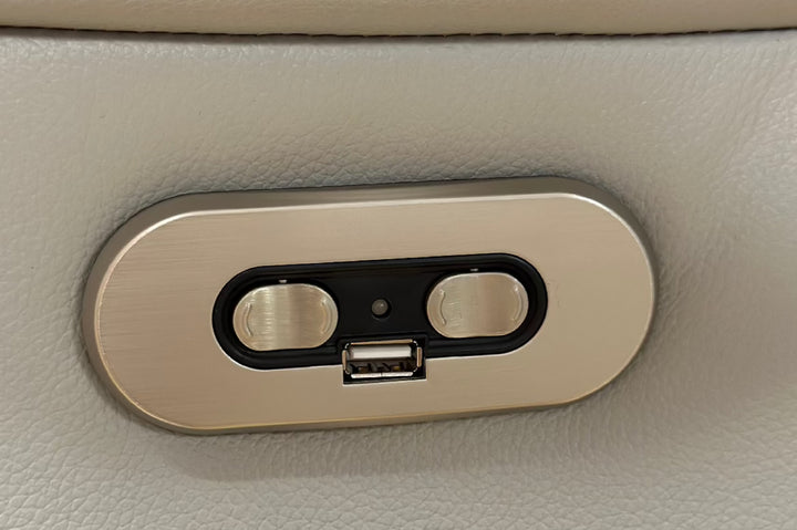 Car interior USB port and charging socket on beige leather