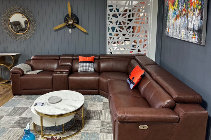 Brown leather sectional sofa in a living room with decorative elements.