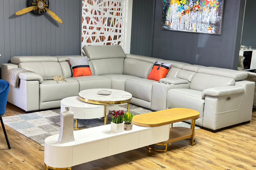 Modern living room with a sectional sofa, coffee table, and decorative elements.