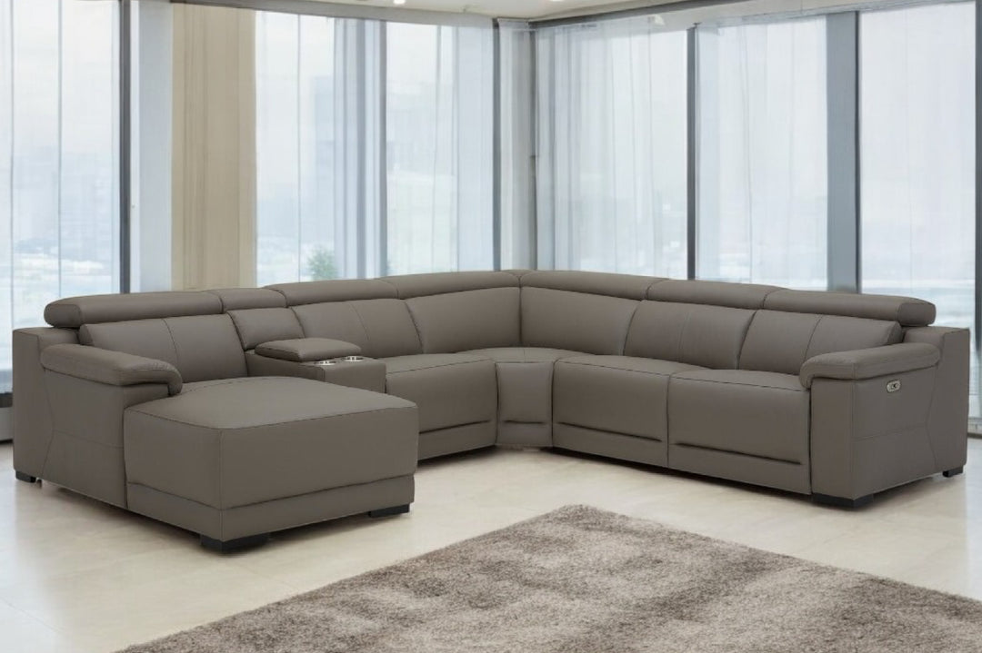 Gray sectional sofa in a modern living room with large windows.